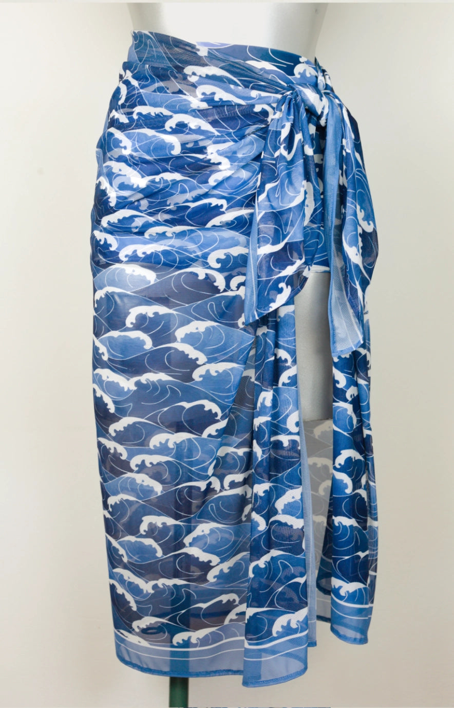 Blue and white patterned waves sarong on a mannequin against a plain background