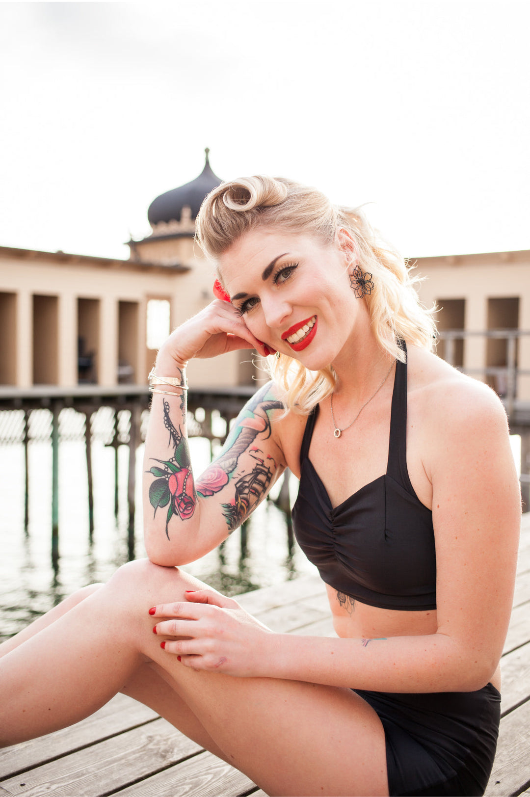 Retro Model sitting in Black Simple bikini top with gathered bust detail.