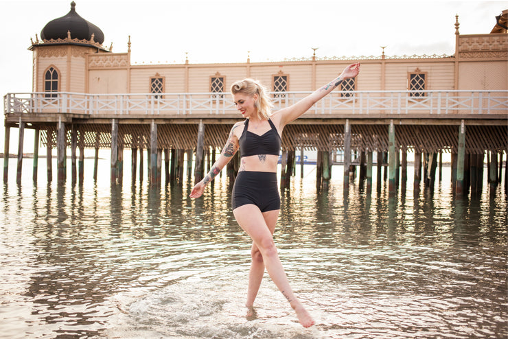 Retro Model wearing Black Simple bikini in front of Varbergs kallbadhus.